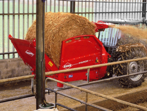 KUHN PRIMOR 2060 M Straw Blower spreading haylage in livestock pens.