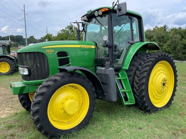 2009 John Deere 7430 Premium parked on a farm field